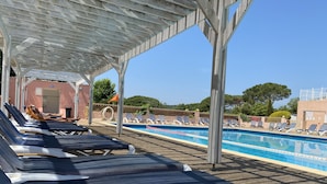 A poolside area with lounge chairs and a covered seating area. - Rental St tropez Gassin luxury bungalow 6pers (Gassin)