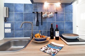 Fridge, stovetop, coffee/tea maker, cookware/dishes/utensils