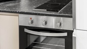 A kitchen with a built-in oven and a stovetop.