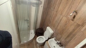 A bathroom with a glass-enclosed shower, a toilet, and a sink. - Apartments House Marija - Studio Apartment with Balcony (Vrbanj)