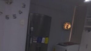 A room with a long, beige countertop, a clock on the wall, and a refrigerator in the background. - Apartment Quinto #2 (Quito)