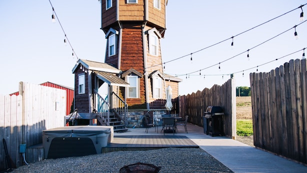 A backyard with a wooden deck, a barbecue grill, a fire pit, and a covered seating area. - Legacy Lighthouse, Amish Country Ohio, Sugarcreek (Sugarcreek)