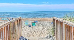A wooden boardwalk leading to a sandy beach with beach chairs and umbrellas. - 2BR Oceanfront Condo with Community Pool & Elevator (North Topsail Beach)