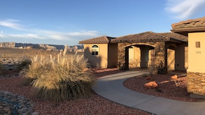 A house with a stone facade, a tiled roof, and a number '385' on the side. - Luxury Near Lake Powell & Antelope Canyon: Hot Tub, Views & EV Charger (Page)
