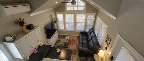 A loft-style apartment with a kitchen, dining area, and living room.