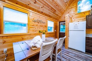 Cozy cabin-style room with a dining table and comfortable seating for two.