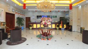 A hotel lobby with a reception desk, a chandelier, and potted plants. - Greentree Inn Yancheng Jianhu East Huiwen Road Columbus Square Business Hotel (Yancheng)