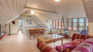 A spacious loft with a dining area, a sofa set, and large windows offering views. - 3 bedroom gorgeous home in Højslev (Højslev)