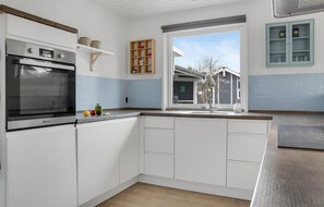 Fridge, stovetop, dishwasher, coffee/tea maker