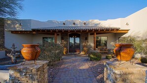 A house with a tiled roof, a stone pathway, and two large pots on either side. - Custom home with heated spa and pool, 1 acre, No HOA, bring Rvs (Phoenix)