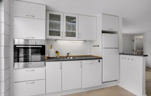 Fridge, stovetop, dishwasher, coffee/tea maker