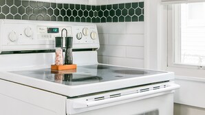 Een keuken met een magnetron, fornuis en oven.