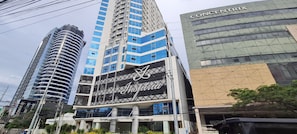 A modern building with a prominent 'Inspiration' sign, surrounded by other high-rise buildings.