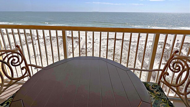 A wooden deck with a view of a sandy beach and the ocean. - 👣 Come get your toes in the sand ~~~ and a cold drink in your hand! 🍹 (Gulf Shores)