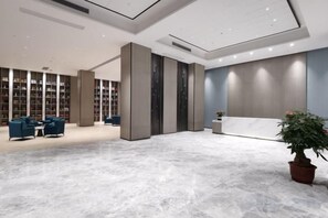 A spacious lobby with a marble floor, seating area, and a reception desk. - Kastin Hotel (Shantou)