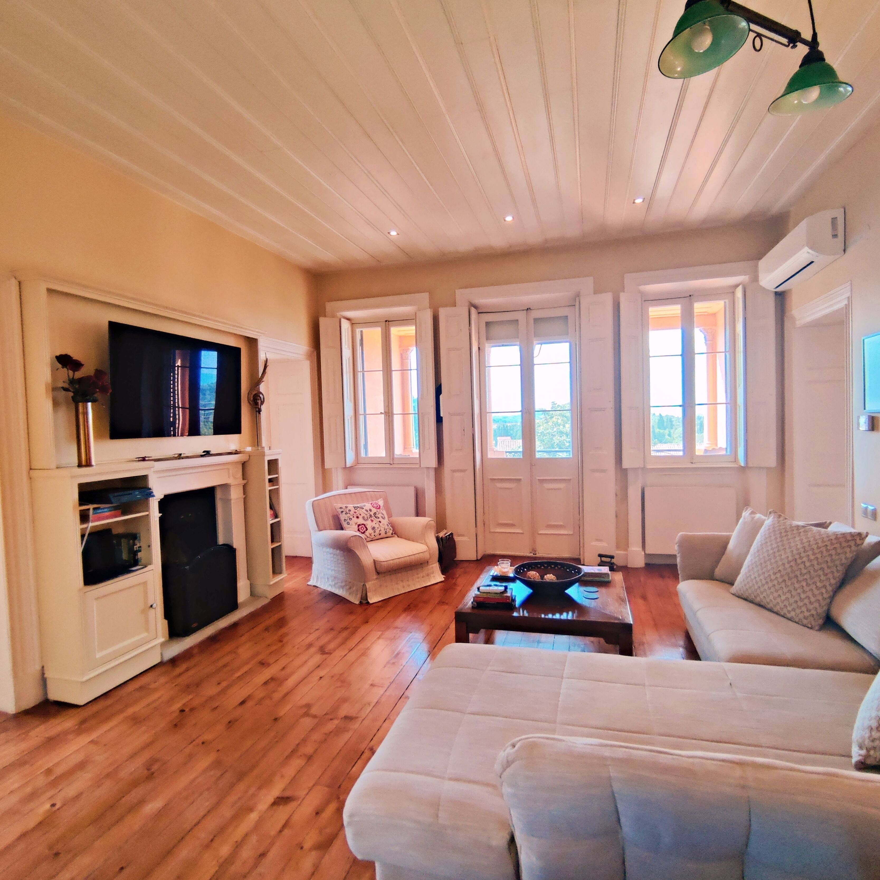 A spacious living room with a fireplace, a sofa, a chair, and a coffee table.