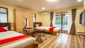 A hotel room with two beds, a dining table, and a TV. - MeroStay 025 Atithi Satkar (Mahamanjushree Nagarkot)