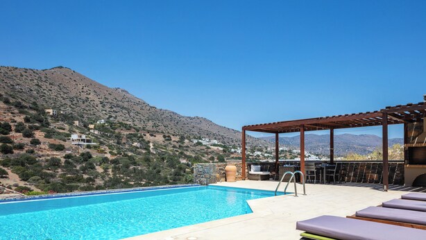 A swimming pool with a view of a mountainous landscape, a pergola, and outdoor seating. - Sea views, short drive to the beach and shops! (Agios Nikolaos)