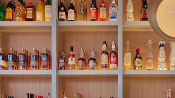 A liquor store with multiple shelves of various alcohol bottles and glasses.