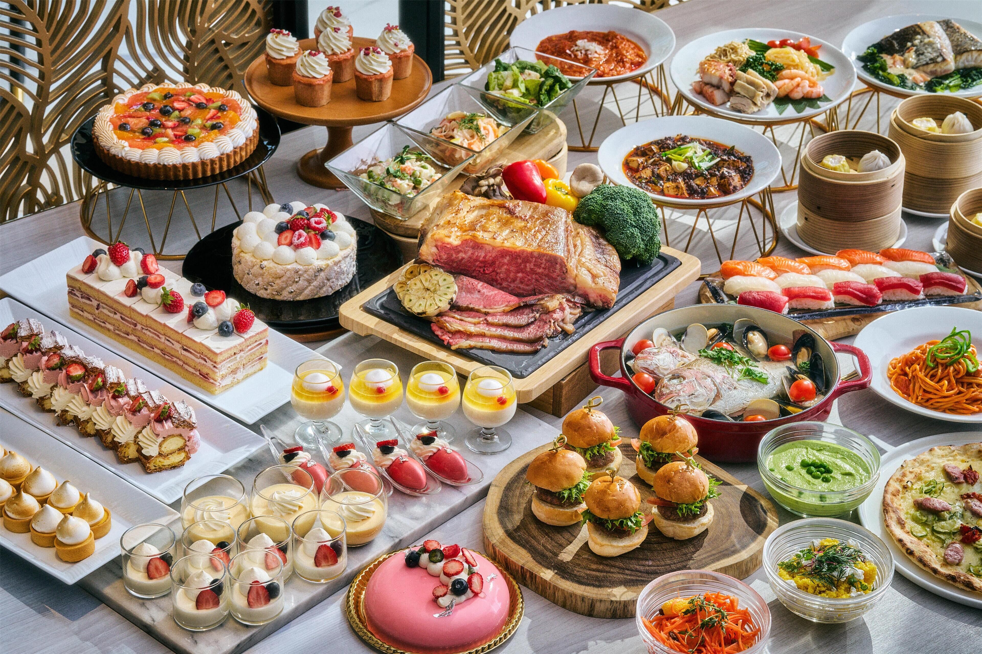 A variety of desserts and dishes on a buffet table.