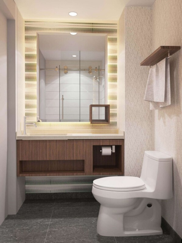 A modern bathroom with a large mirror, a toilet, and a shower area.