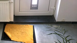A door with a vertical light panel, a doorknob, and a small window.