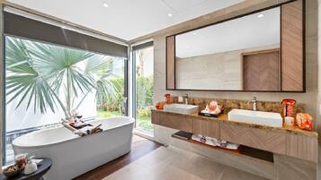 Een aparte badkuip en douche, gratis toiletartikelen, een haardroger