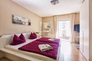 Relax in a stylish room with a large bed, bedside table, and large window.
