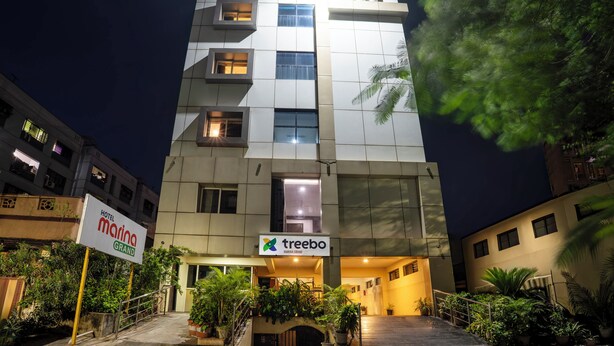 A multi-story hotel with a modern design, featuring a prominent entrance with a sign for 'Hotel Marina Grand' and 'Treebo'. - Treebo Marina Grand, Railway Station (Visakhapatnam)