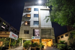 A multi-story hotel with a modern design, featuring a prominent entrance with a sign for 'Hotel Marina Grand' and 'Treebo'. - Treebo Marina Grand, Railway Station (Visakhapatnam)