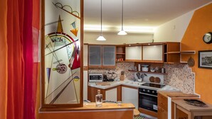 A kitchen with wooden cabinets, a microwave, a stove, and a sink.