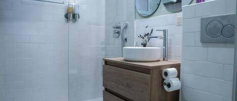 Shower, hair dryer, towels, toilet paper
