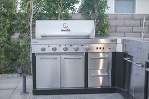 A Char-Broil gas grill with a stainless steel finish, multiple burners, and a built-in oven. - Stardust: Pool, Spa, FirePit, BBQ, EV Charger! (Indio)