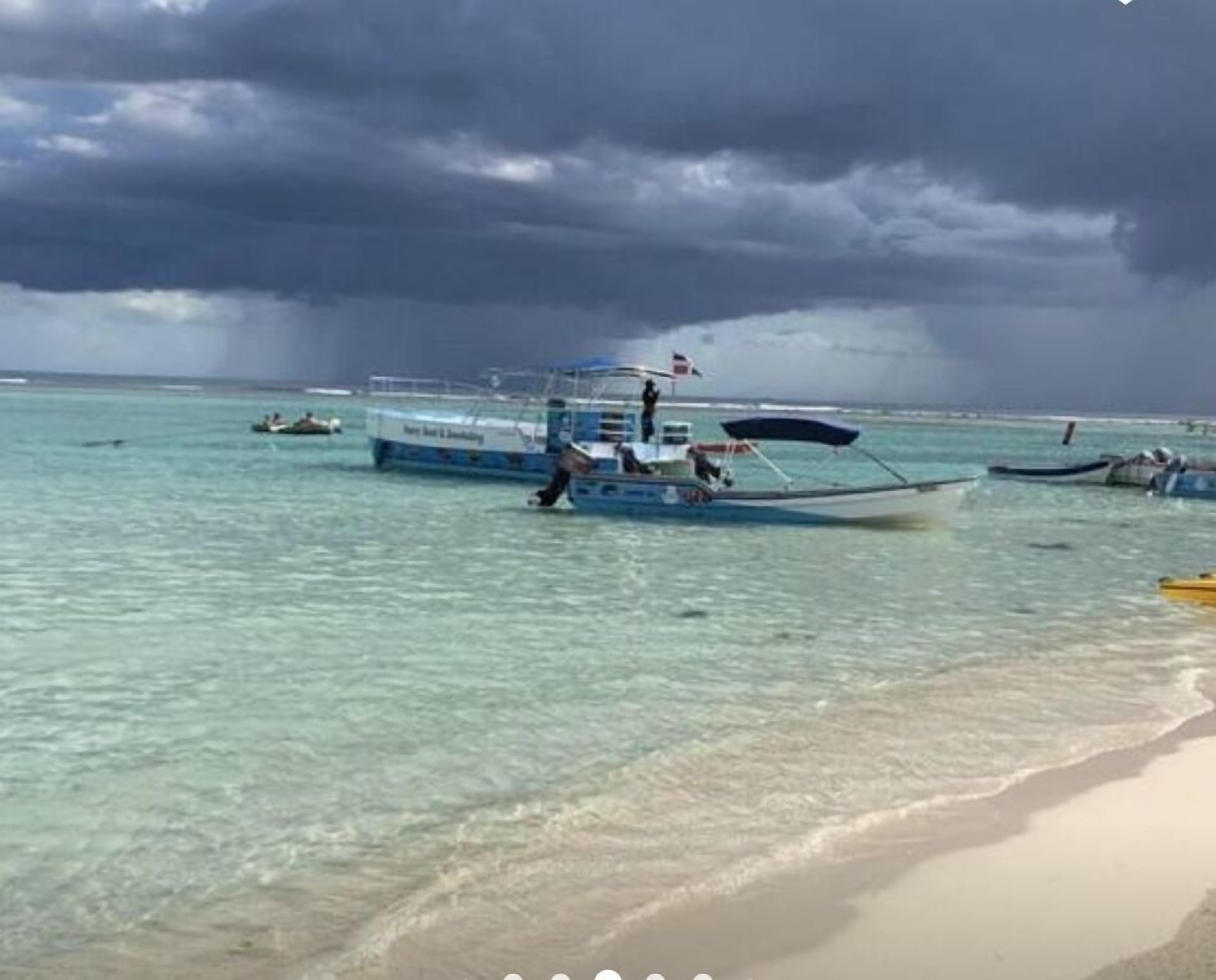 A beach with several boats anchored near the shore.