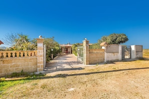 A gated entrance with a clear pathway leading to a building.
