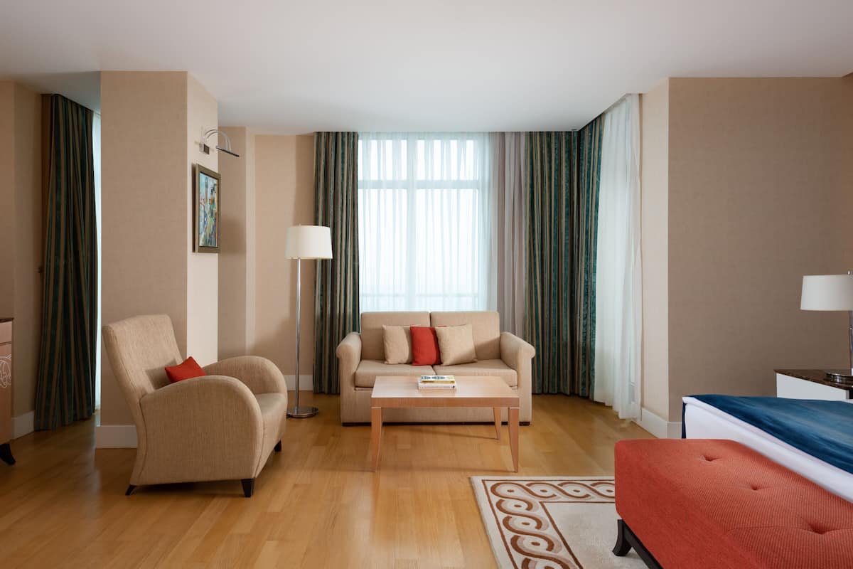 A modern living room with a sofa, a coffee table, and a TV.