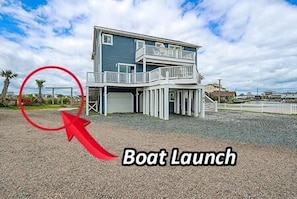 A two-story house with a balcony, a garage, and a driveway. - 5BR Ocean View House - Hot Tub - Boat Access (North Topsail Beach)