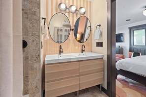 Gorgeous tile and double vanity.