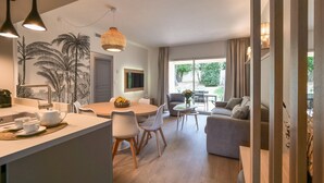 A modern living room with a dining area, a sofa, and a coffee table.
