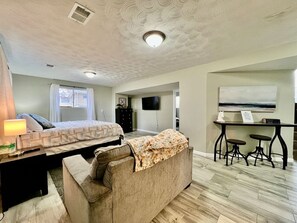 A room with a bed, a sofa, a desk, and a television. - 6268 Mullen · Among trees outside the city (Cincinnati)