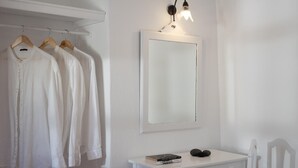 A white room with a desk, chair, and a clothing rack. - Madame Kalitsi-ioli Standard Room (Santorini)