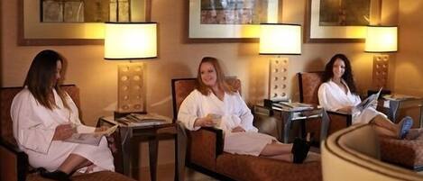 A spa area with three reclining chairs, each with a lamp and a small table.