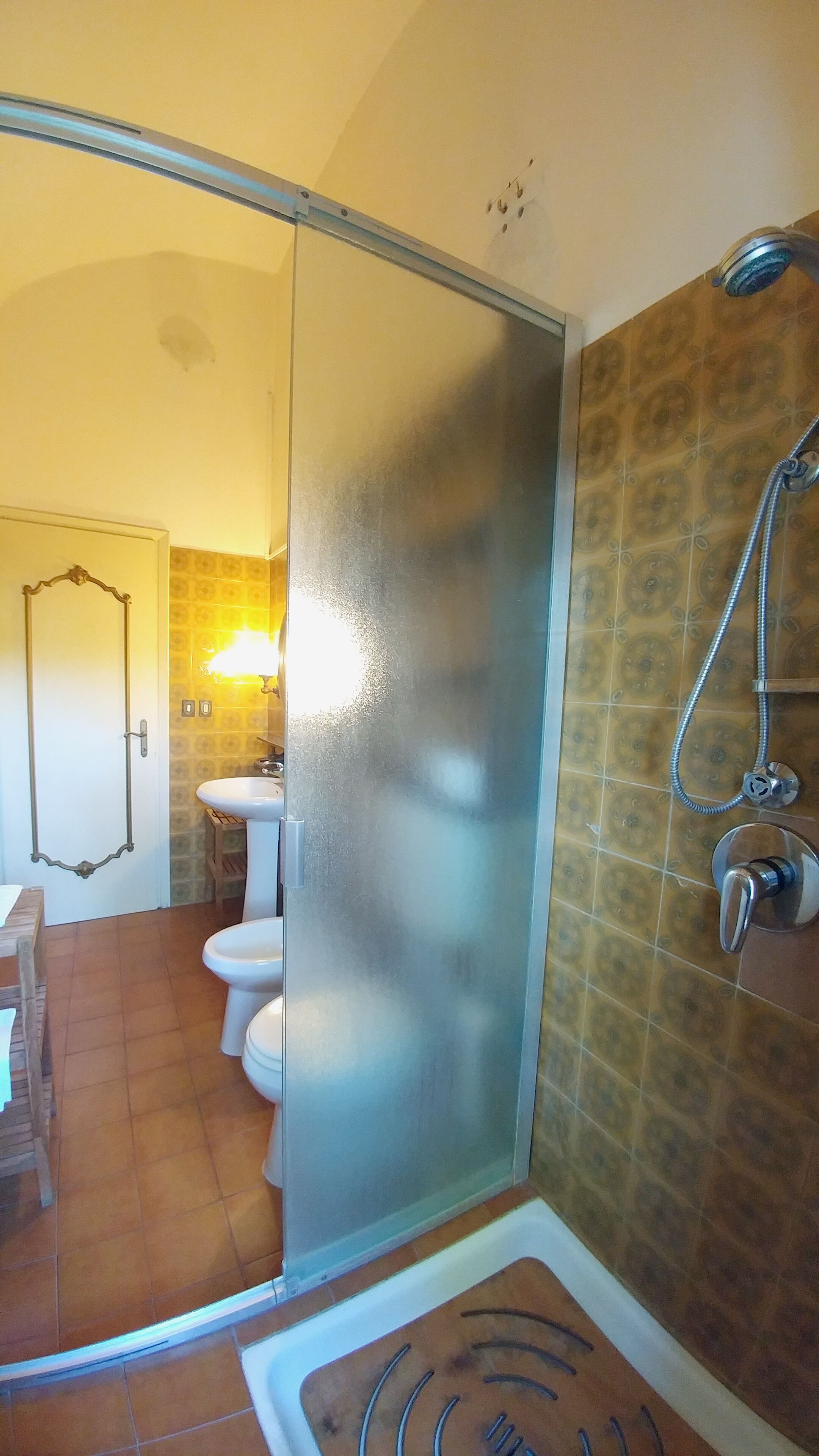 Un bagno con doccia, toilette e lavabo.