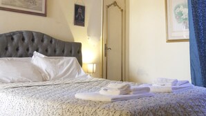 A bedroom with a bed, a door, and a ceiling with decorative patterns. - Bresbot (Bressana Bottarone)