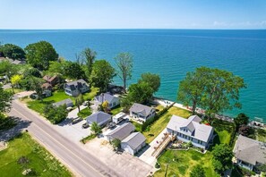 Stunning views of a serene body of water surround homes in a semi-urban setting.