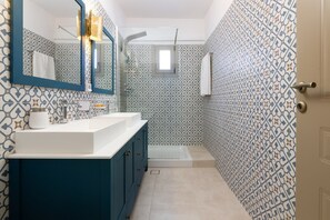 Shower, hair dryer, towels, toilet paper