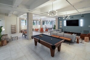 Relax and socialize around the pool table, surrounded by comfortable seating and a large flat-screen TV.