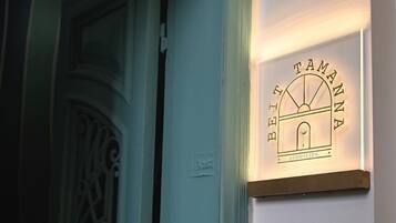 A sign with the text "BEIT TAMANNA" and "GEMMAYZEH" indicating the name of a hotel or establishment.