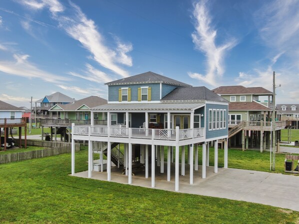 A two-story house with a balcony and a covered porch.