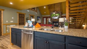 A kitchen with granite countertops, stainless steel appliances, and wooden cabinetry. - Time for Us (Gatlinburg)
